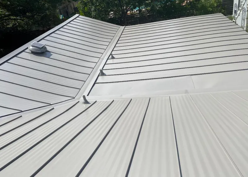 Solar attic fan installed on a metal roof for Roof Ventilation in Blue Island
