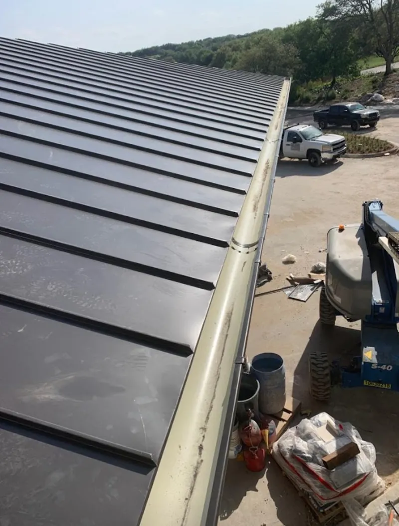 Standing seam panel and gutter detail on a metal roofing jobsite in Blue Island
